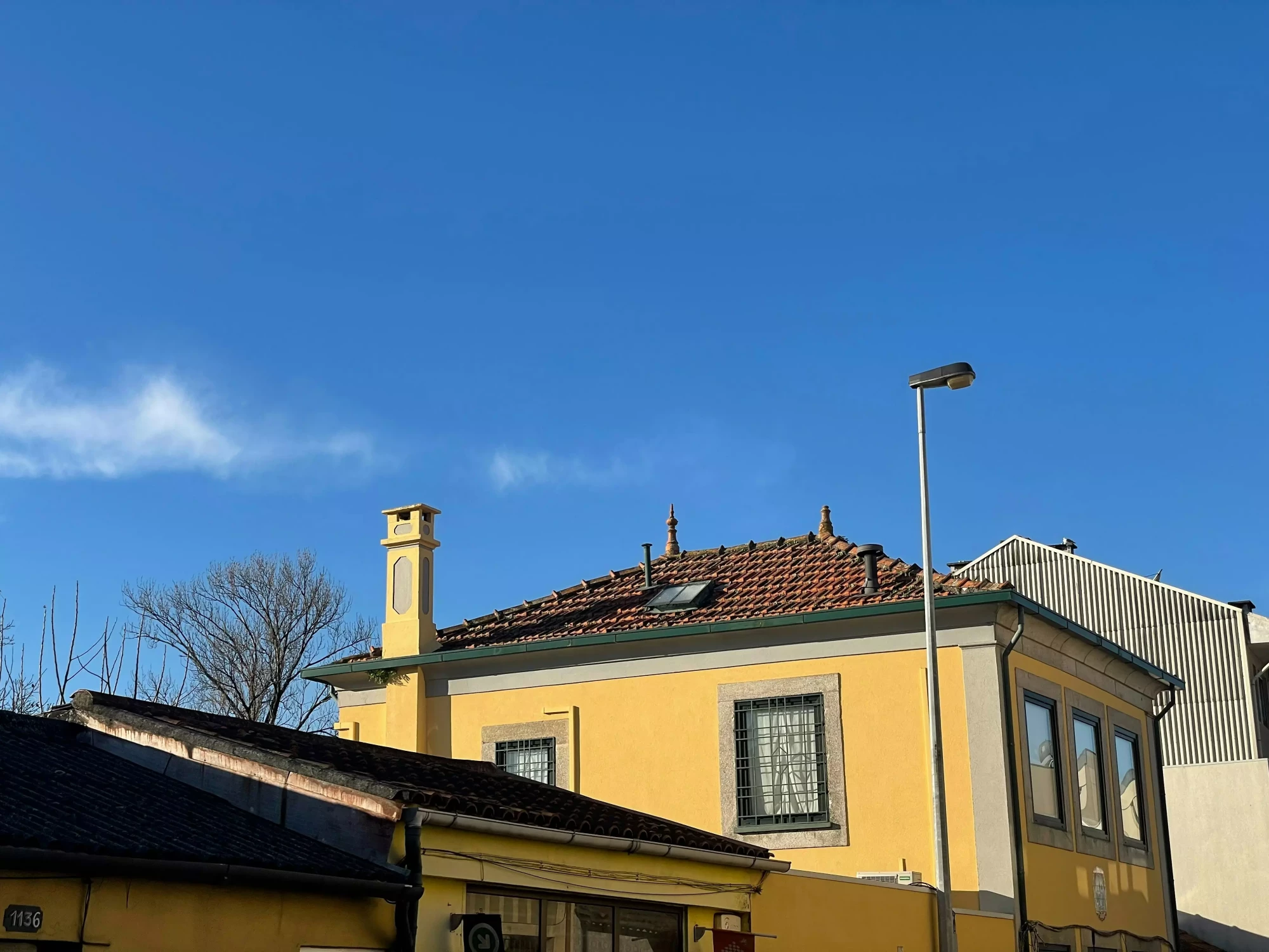 Beautiful renovated house roof in Lyon with blue sky in background